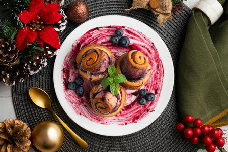 Blueberry and cinnamon rolls with a Swedish recipe. Top view table with christmas decorations.