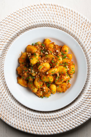 Dish of Italian gnocchi with tomato and meat Bolognese sauce. Top view table with christmas...