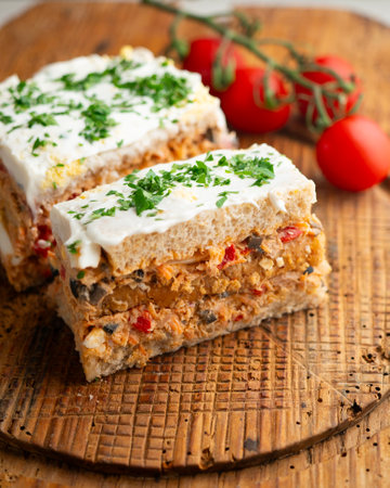 Cold tuna pie with vegetables and sliced bread.