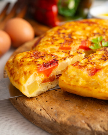 Traditional Spanish omelet with potato, egg, and red pepper. A traditional Spanish tapas recipe.の写真素材