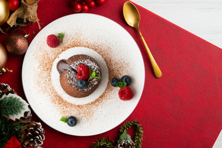Beautiful chocolate lava cake coulant from a top view with christmas decorations.の写真素材