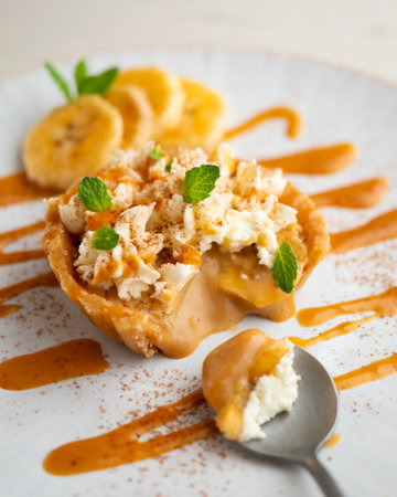 Banoffee tart filled with caramel, fresh banana and whipped cream.の写真素材