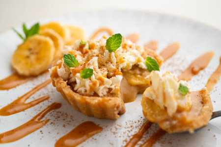 Banoffee tart filled with caramel, fresh banana and whipped cream.の写真素材