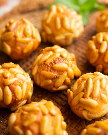 Panellets with pine nuts and almonds. A typical Catalan dessert made with marzipan and nuts.の写真素材