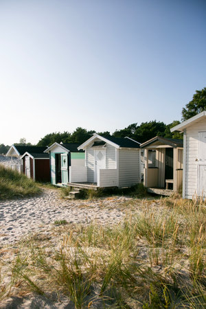 Small beach huts used for storage during holidays on the Danish coast, facing the Baltic Sea.