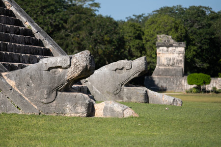 The iconic El Castillo pyramid, also known as the Temple of Kukulcan, stands majestically against a vibrant blue sky, showcasing its ancient Mayan architecture at Chichen Itzaの写真素材