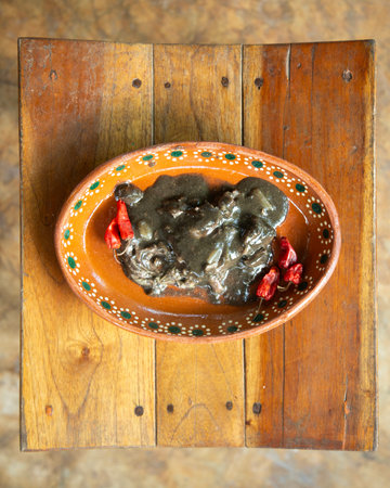 Relleno negro is a typical hot dish from the YucatÃ¡n Peninsula. It consists of turkey and pork, a sofrito, and a mixture of dried chilies called "chilmole" or "recado negro," whichの写真素材