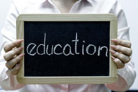 Young women holding blackboard, words written with white chalkの写真素材