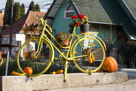 Design of a yellow bike along to a few halloween pumpkinsの写真素材