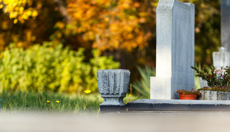Old grave in a catholic cemetery in Europe during the fall seasonの写真素材