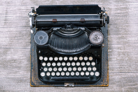 Old typewriter on a textured grey backgroundの写真素材