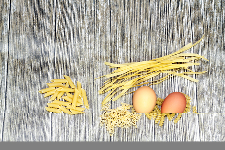 Italian food ingredients, pasta, flour, eggs and kitchen accessoriesの写真素材