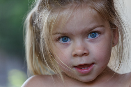 Close up photo of a beautiful blonde blue eyes girl's portraitの写真素材