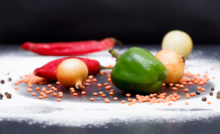 Vegetables laying on a table with saturated colour and black backgroundの写真素材