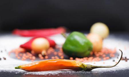 Vegetables laying on a table with saturated colour and black backgroundの写真素材