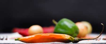 Vegetables laying on a table with saturated colour and black backgroundの写真素材