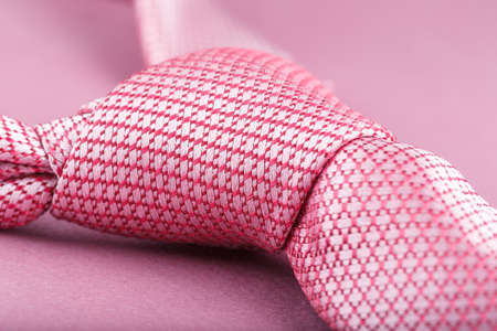 Close-up shot of a pink tie on violet background, fashion accessoriesの写真素材