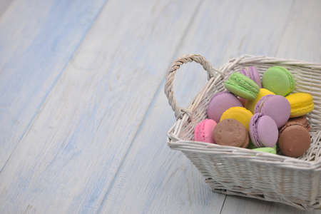 multi-colored circular cookies in a wicker basketの写真素材