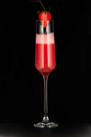 one glass cup with strawberry drink and strawberries on dark backgroundの写真素材