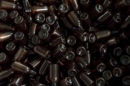 a large number of transparent glass bottles of dark color closeupの写真素材