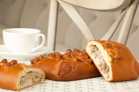 cake and cup of coffee on the table against the background of the chair