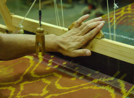 Hand made on a wooden loom manufacture of thread and fabric closeup