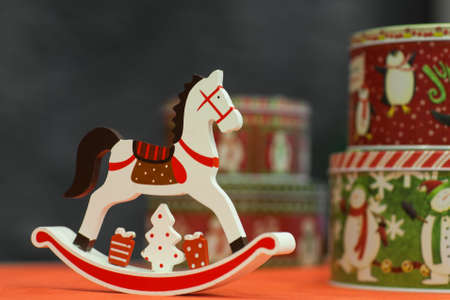 little toy rocking horse with a gift box on a blurred backgroundの写真素材