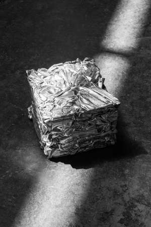 compacted into a cube of aluminum metal and illuminated strip lightsの写真素材