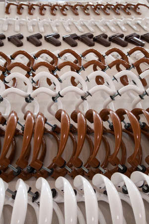 a set of white and brown metal handles and accessories for plastic windows and doorsの写真素材