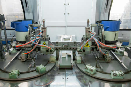 closeup of the machine for the manufacture and assembly of door and window hinges
