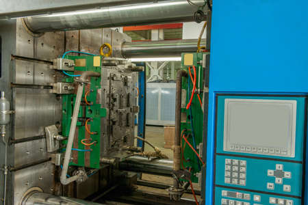 closeup of industrial molding press machine for the manufacture of plastic parts using polymersの写真素材