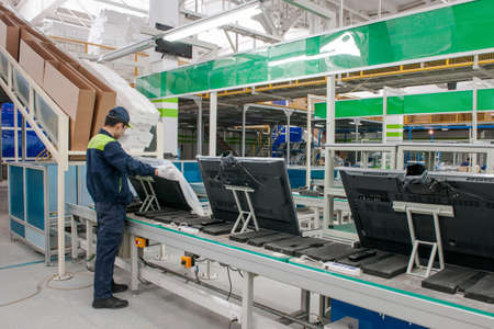 closeup line conveyor assembly and packing televisions in a workshopの写真素材