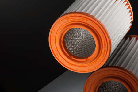 automotive filter cylindrical shape on a black background with reflection
