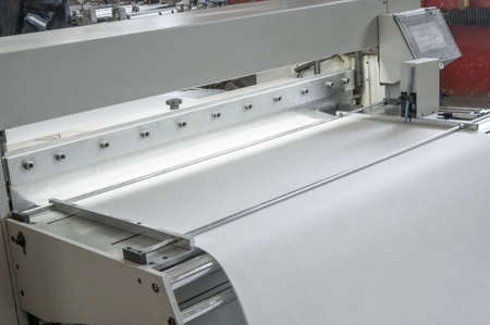closeup of the machine and equipment are cut and furrowing the felt fabric for automotive filters