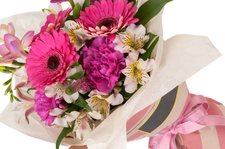 carnation and gerbera in a paper bouquet tied ribbon on a white background. Valentine's Dayの写真素材