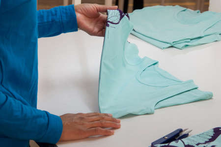 at a garment factory quality control check for defectsの写真素材