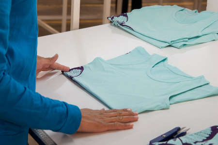 at a garment factory quality control check for defects