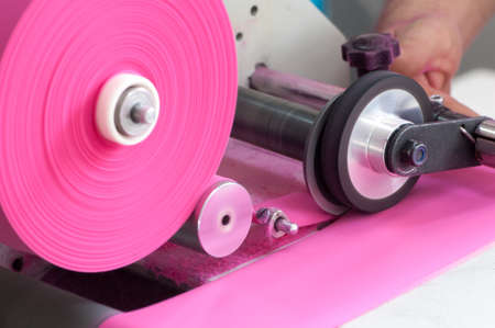 machine for cutting and winding the cloth onto the spool closeup