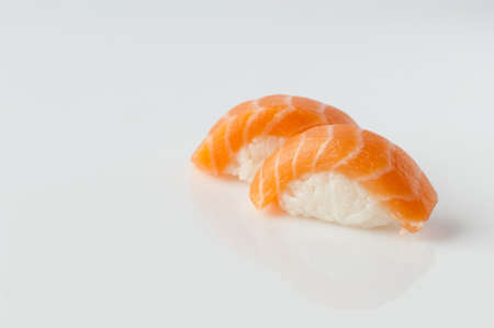 close up of sushi with rice on white background with reflectionの写真素材
