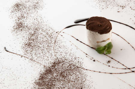 a piece of cake with sprinkled with powdered sugar on a white backgroundの写真素材