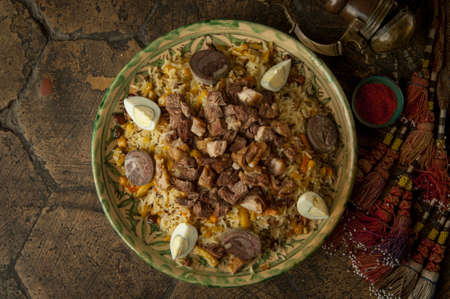 oriental dishes on decorative old tiles. pilaf and pitcher on decorative old paving stonesの写真素材