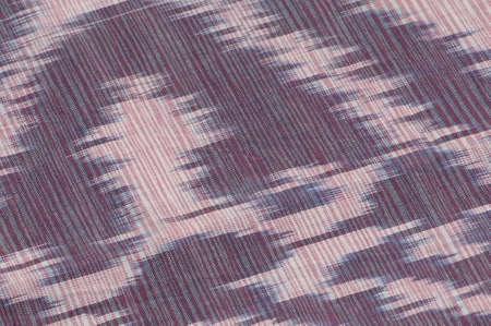 background of silk fabric with oriental ornaments. uzbek silk with ornament