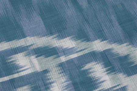 background of silk fabric with oriental ornaments. uzbek silk with ornament
