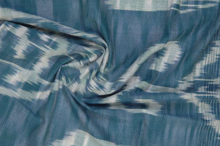 background of silk fabric with oriental ornaments. uzbek silk with ornament