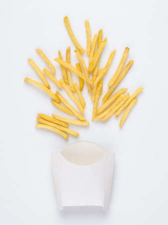 On a white background fried french fries in a white box. studio photo of fried french fries on white backgroundの写真素材