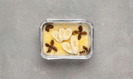 fast food in a foil box on a gray background. a healthy food close upの写真素材