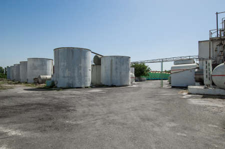 reservoir in a row and a building on a farm. heavy industrial plant