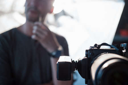 Digital camera close-up on the background silhouette a photographerの写真素材