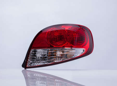 close up of a red car taillight on a light background with reflection. isolatedの写真素材