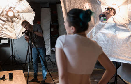 photographer in the process of shooting a model in a photo Studioの写真素材